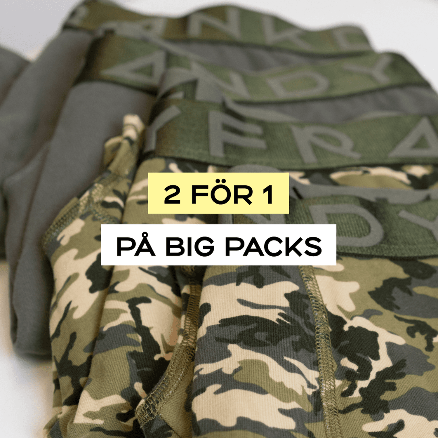 Camouflage-patterned underwear on display with a "2 för 1 på big packs" promotional sign.